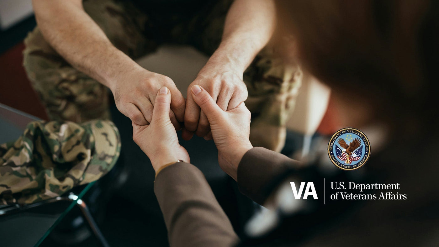 Veteran shaking hands with clinician beside VA logo — representing VA-approved Luggie mobility scooters
