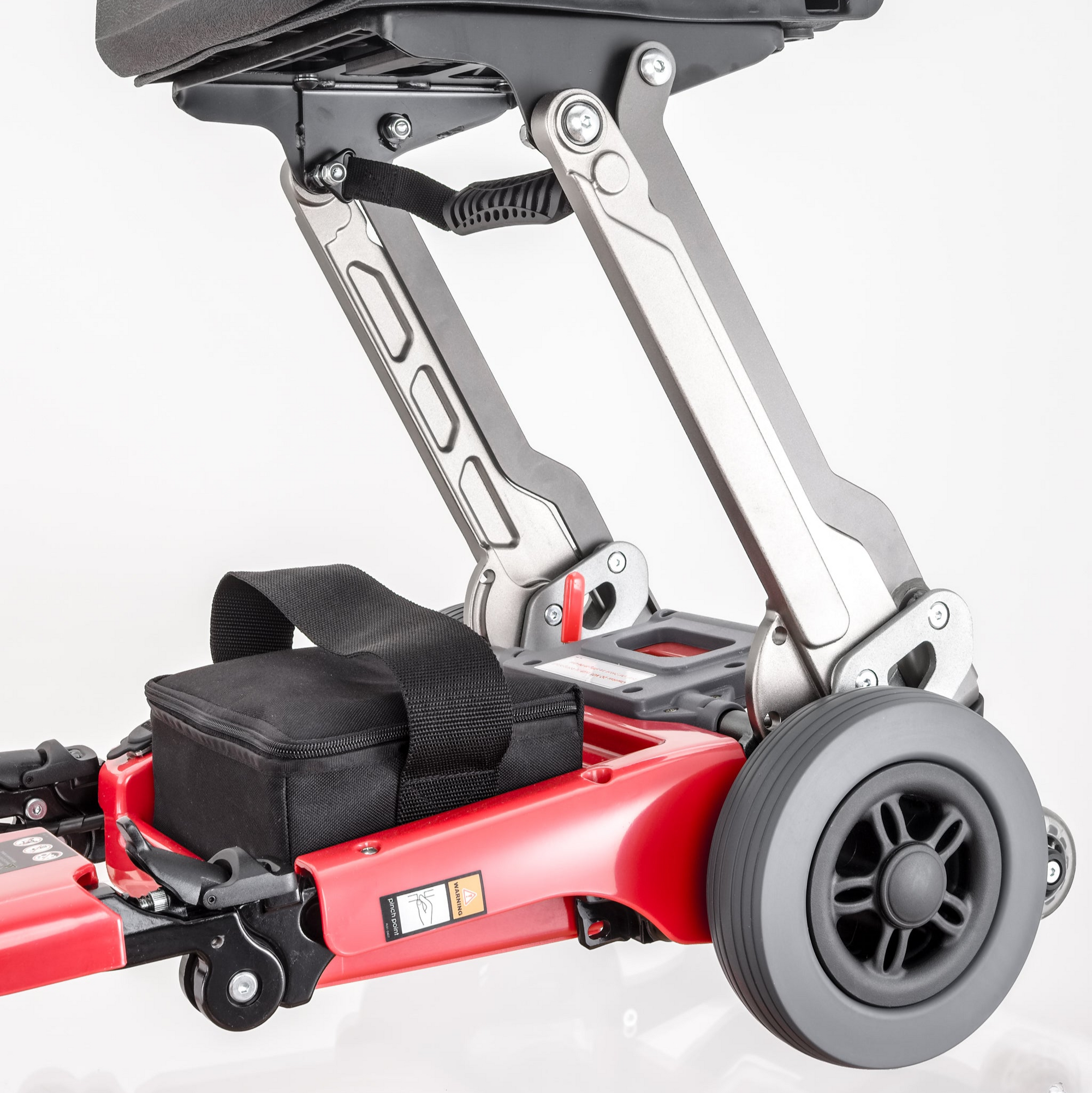 Luggie Elite fully folded, standing upright inside of a half opened, red travel semi-hard suitcase with wheels. 