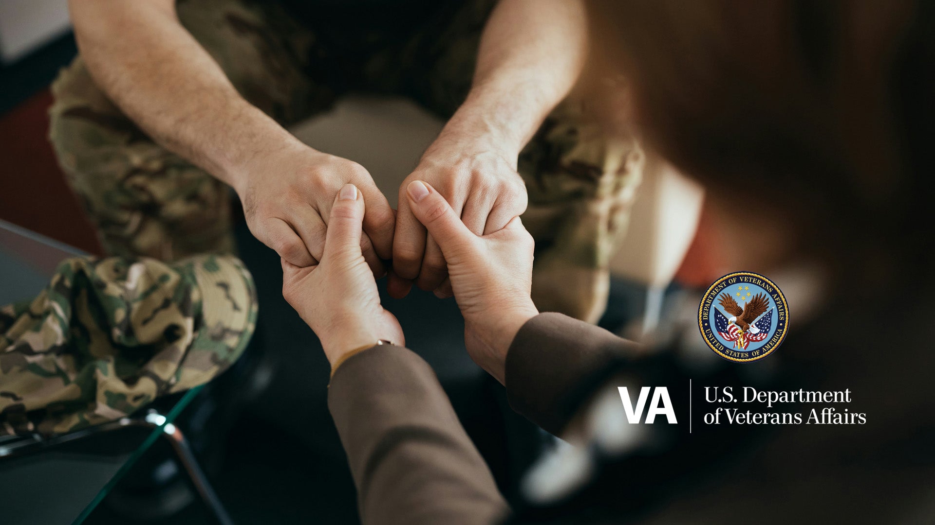 Two people holding hands with a U.S. Department of Veterans Affairs logo in the corner.